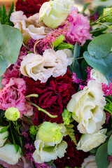 Red white purple rose bouquet with two golden wedding rings hidden