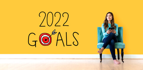 2022 goals concept with young woman holding a tablet computer