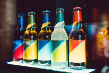 Soda bottles of different colors on a shelf