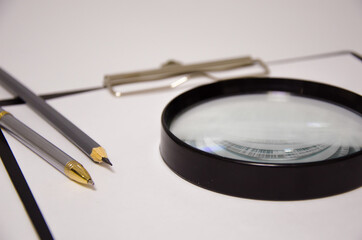 white sheet magnifier pen lies on a white background