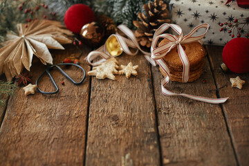 Merry Christmas! Christmas cookies and festive decorations on rustic wooden table. Atmospheric stylish christmas composition with oatmeal cookies and xmas presents. Space for text. Happy holidays