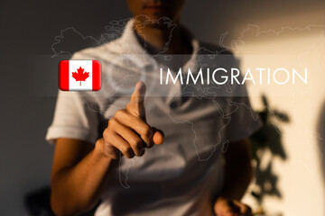 Canada immigration concept. Man pressing virtual button with flag icon