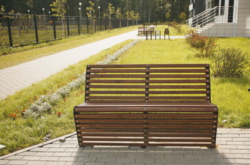 wooden bench on street in new neighborhood