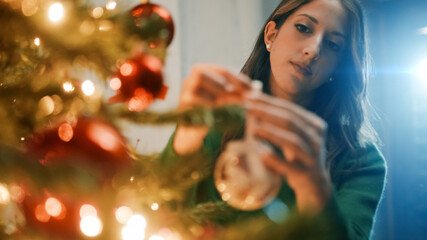 Girl Hangs Balls On Christmas Tree