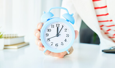 Fototapeta na wymiar alarm clock in hand. Time management. Time take action. Deadline concept.