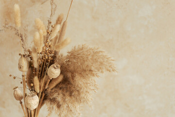 Bouquet of beautiful beige dried flowers. Home decoration concept. Place for text.