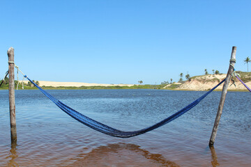 Obraz premium Hammock in lagoon overlooking dunes.
