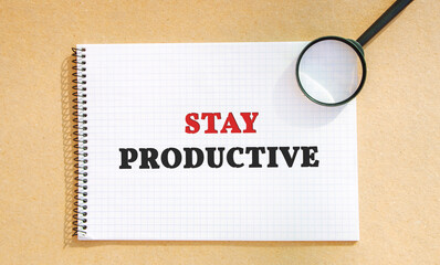 Notebook with the words Stay productive. The concept of motivation and achievement of the set goals. Organization of time. Efficiency, productivity. Business and education.