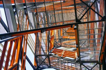 a fragment of the structure of a new modern metal observation tower with decorative wooden elements