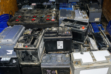 Pallet with many used car batteries for recycling