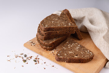 rye flour bread with seeds on a white background