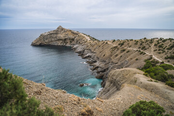 Fototapeta na wymiar Cape Kapchik and Golitsyn trail at rocky Black Sea coast at sunny day, Novyi Svit, Sudak Municipality, Crimea
