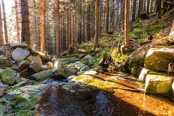small waterfall on a river in czech mountains