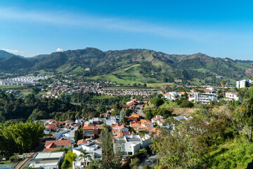 Fototapeta na wymiar Panoramic and urban landscape of the city of Manizales and blue sky. Manizales, Caldas, Colombia.