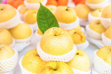 Stacks of fresh organic ripe yellow apples packed in baskets at healthy food market