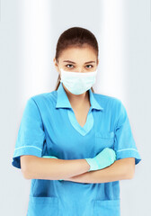 young nurse putting on a medical mask and gloves