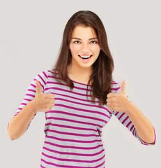 Girl laughing at camera with thumbs up