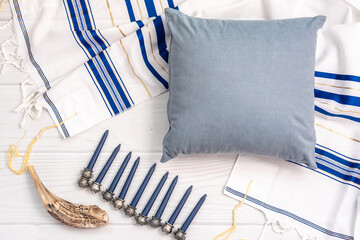 Festive composition with traditional Jewish items and blank grey pillow with space for design on...