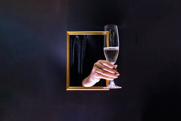 Hand gives champagne. They offer to drink a glass of champagne.