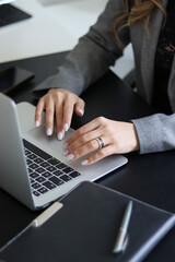 person typing on the keyboard. girl typing on the computer.office. notepad and computer. office worker. laptop on table