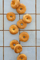 Top view of choux pastry donuts on kitchen tile background