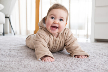 Happy baby crawling on floor or carpet