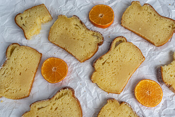 pieces of cake with oranges on a white background top view