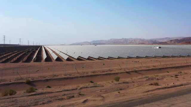Aerial View of Solar Panel Park or farm Solar panels in the desert among the mountains in Timna, Israel. Drone Aerial Shot Of Power Station Over Landscape On Sunny Day Against Sky at the Negev, Israel