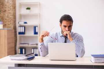 Young male employee working in the office