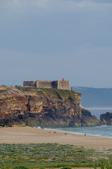 Praia do Norte beach, cliffs and Nazar&eacute; lighthouse cape. Portugal.