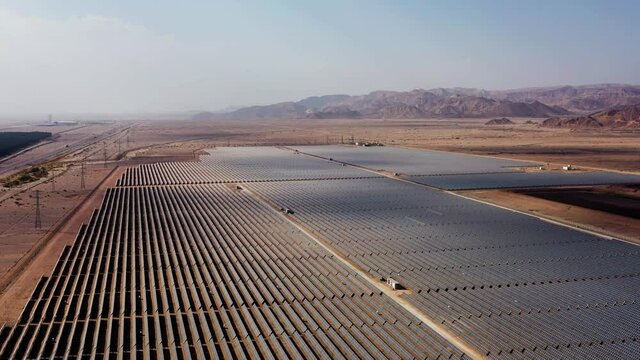 Aerial View of Solar Panel Park or farm Solar panels in the desert among the mountains in Timna, Israel. Drone Aerial Shot Of Power Station Over Landscape On Sunny Day Against Sky at the Negev, Israel