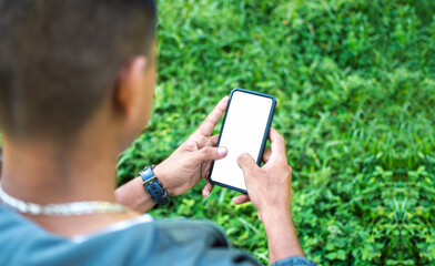 Close up of a man with cell phone in hand, close up of hands with cell phone with white screen, young guy with cell phone in hand with copy space