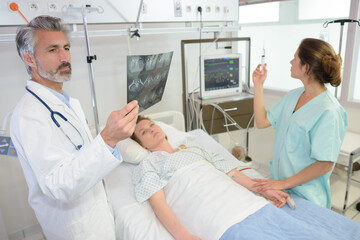 radiologist checks x-ray in hospital room