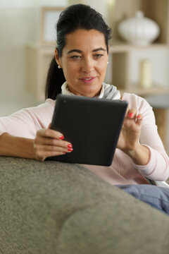 middle age woman checking her tablet