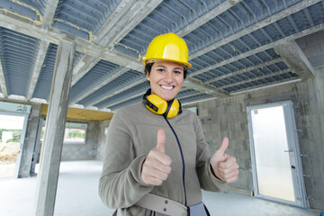 a successful female builder with thumbs up