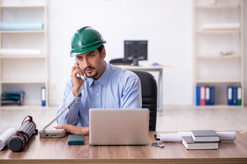 Young male architect working in the office