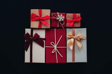 Gift boxes on black background. Christmas concept. Top view, flat lay, copy space