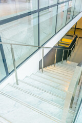 Obraz premium White staircase. Abstract fragment of the architecture of modern lobby, hallway of the luxury hotel, shopping mall, business center in Vancouver, Canada. Interior design.