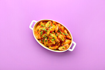 Baking dish with honey chilli potato on color background