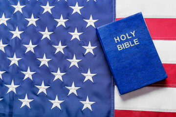 Fototapeta premium Blue Holy Bible on flag of USA