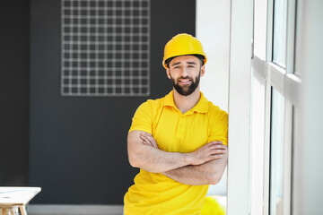 Construction worker with hardhat near window in room