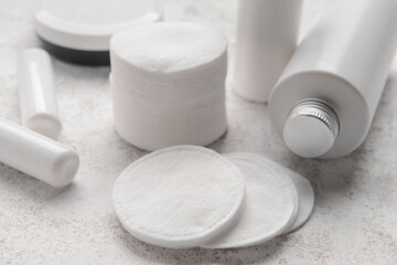 Clean cotton pads and care cosmetics on light table