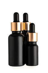 Dark bottles of essential oil on white background