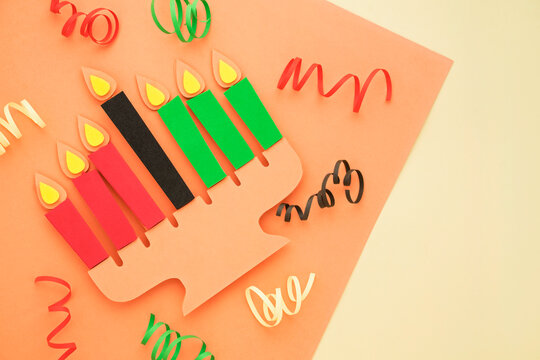 Happy Kwanzaa Greeting Card Background. Candleholder made from paper leaves. Paper art concept
