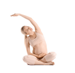 Naklejka premium Young pregnant woman practicing yoga on white background