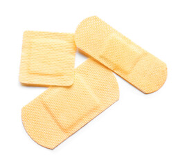 Different medical plasters on white background