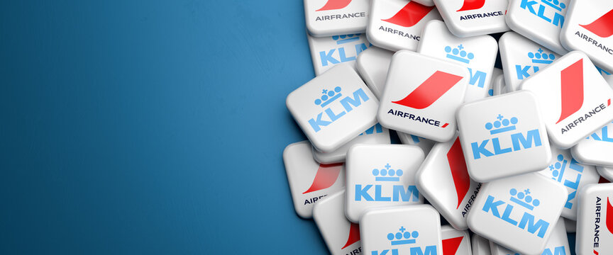 Logos of the merged airlines Air France and KLM on a heap. Copy space. Web banner format.