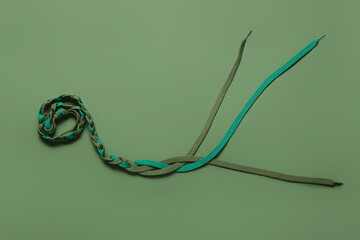 Braided shoe laces on color background