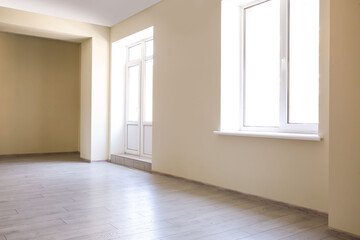 View of big empty room with door and window