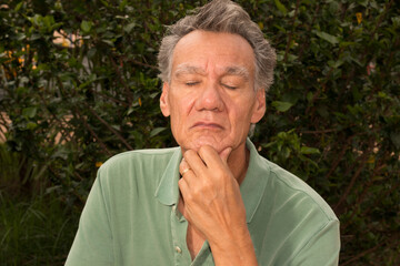 Senior man outside in deep thought about something